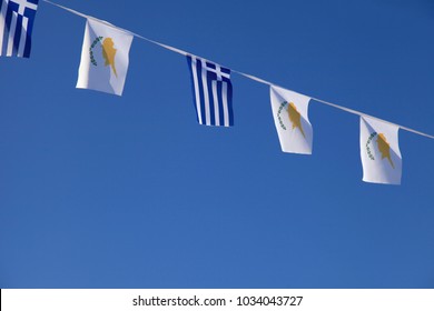 Greece And Cyprus Flags Banner Against Blue Sky. 