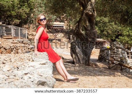 Greece. the island of Zakynthos. Young woman sitting in the reserve on the rocks and basking in the sun