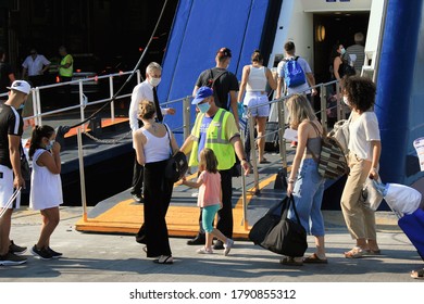 Greece, Piraeus, August 1 2020 - Passengers Embarking On A Ferry Boat With Greek Islands As Destination.