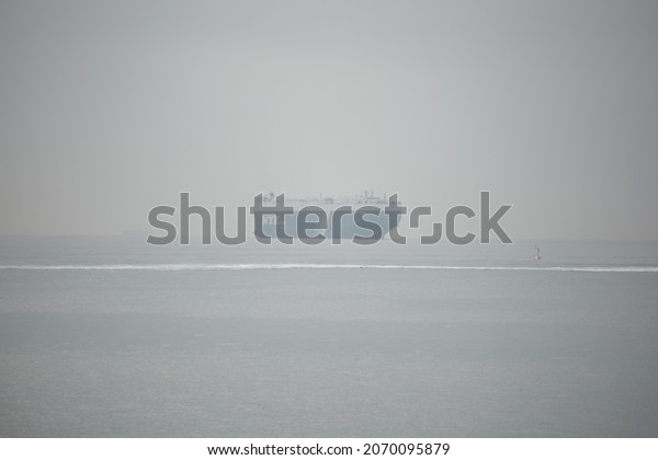 Greece port of Piraius11 6 2021 car carrier ship in mist
entering port 