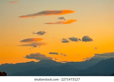Greece. Silhouettes of mountain peaks. Sky with clouds after sunset