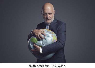 Greedy Corporate Businessman Crushing A Globe: Earth Exploitation And Power Concept