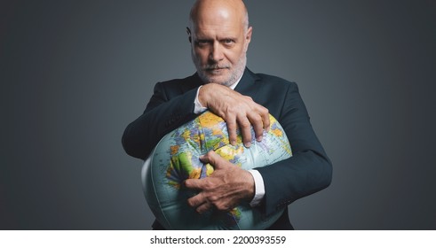 Greedy Corporate Businessman Crushing A Globe: Earth Exploitation And Power Concept