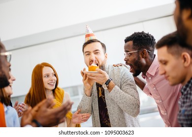 greedy guy is trying to bite a bigger peace of cake in front of hungry shocked friends at work