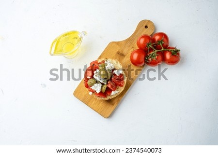 Greek dish dakos on a light background, top view, free space.