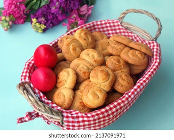 Greek Easter cookies (koulourakia) in a basket and red easter eggs         