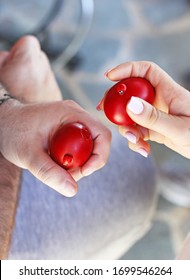 Greek Easter - Hands Holding Cracked Red Easter Eggs - Orthodox Greek Tradition Of Cracking Eggs - Symbolizes Christ Resurrection