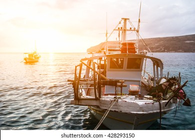 Greek fishing boat at the sunset.