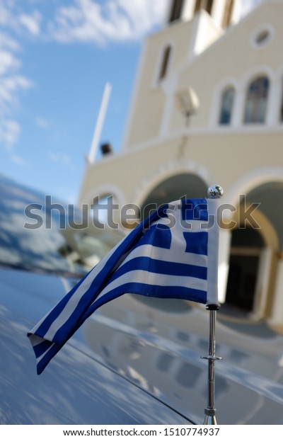Greek flag with\
orthodox church in\
background