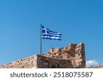 Greek flag waving in Kastellorizo ​​castle, Kastellorizo ​​island, Dodekanisos, Greece