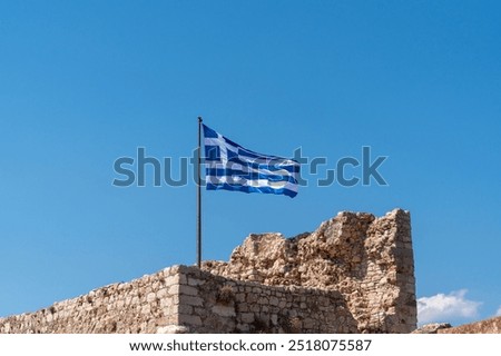 Greek flag waving in Kastellorizo ​​castle, Kastellorizo ​​island, Dodekanisos, Greece