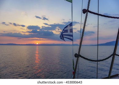 Greek Flag Waving At Sunset In The Messenian Gulf - Greece.
