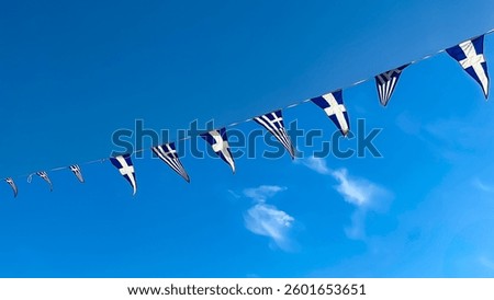 Greek Flags Hanging On A String Against A Clear Blue Sky, Waving In The Wind, National Symbol Of Greece, Patriotic Celebration, Cultural Heritage, Festive Atmosphere, Ideal For Tourism And Events.