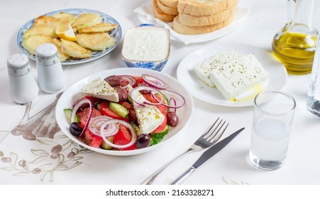 Greek Food Background. Ouzo, Greek Salad, Tzatziki, Assortment Of Feta. Top View. Traditional Greek Taverna Menu. Close Up