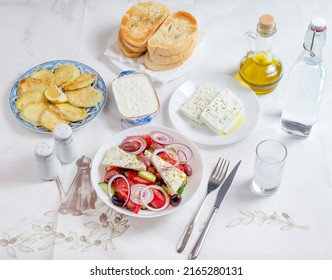 Greek Food Background. Ouzo, Greek Salad, Tzatziki, Assortment Of Feta. Top View. Traditional Greek Taverna Menu. Close Up