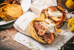 Greek Food. Gyros Souvlaki Wrapped In A Pita Bread On A Wooden Background