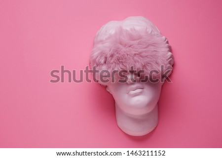 Greek goddess sculpture with sleep mask on pink background, sleeping concept