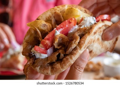 A Greek Gyro Sandwich In A Customer's Hand