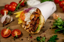 Greek Gyros Wrapped In Pita Breads On A Wooden Background