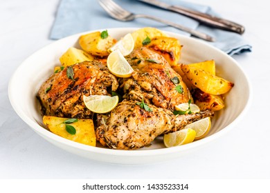 Greek Lemon Chicken With Potatoes In A Bowl On White Background. 