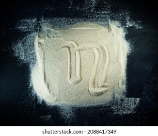 Greek letter eta written on a white sand with black background