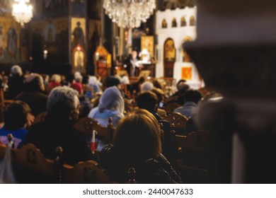 Greek Orthodox Christian Easter ceremony procession, divine worship service, worshippers hold candles, parishioners during an Easter vigil mass in a Cathedral, Athens, Attica, Greece, divine liturgy - Powered by Shutterstock