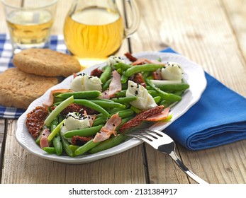 A Greek Plate Made Of Green Beans, Slices Of Fried Bacon, Sundried Tomato And Spoonfuls Of Fetta Mousse.it Is Served With Retsina And Cretan Roasted Bread,called Ntakos.