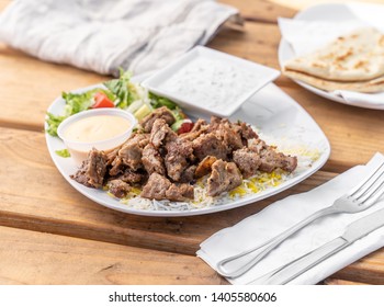 Greek Platter With Lamb Gyro Meat, Rice, And A Side Salad Served In A Mediterranean Restaurant.