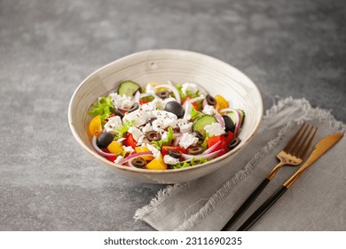 Greek salad of fresh cucumber, tomato, sweet pepper, arugula, red onion, feta cheese and olives with olive oil. Healthy food. - Powered by Shutterstock