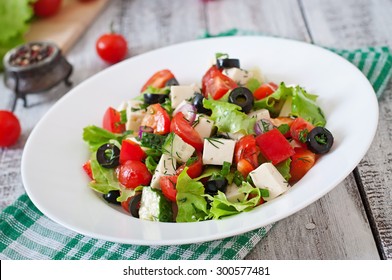 Greek salad with fresh vegetables, feta cheese and black olives - Shutterstock ID 300577481