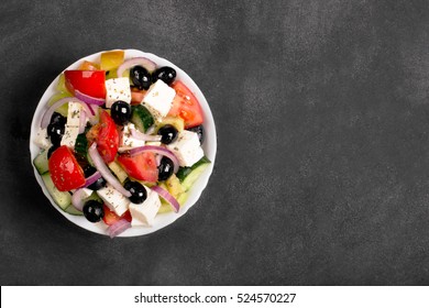 Greek Salad With Fresh Vegetables, Feta Cheese And Black Olives. Top View