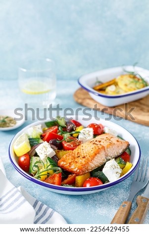 Greek salad with grilled salmon fish. Traditional mediterranean cuisine. Healthy food, diet