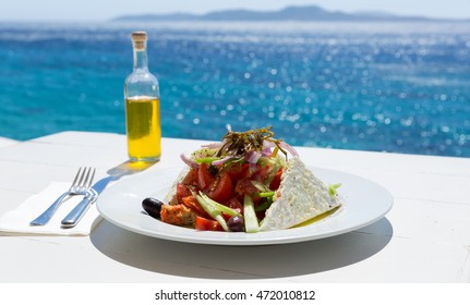 Greek Salad And Olive Oil On Sunny Sea Setup