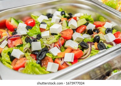 Greek Salad In Stainless Bowl Close-up. Bistro Menu, Chopped Vegetables And Cheese. Appetizing Mix. Selective Focus