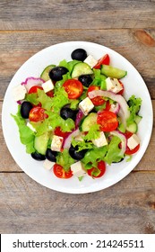 Greek Salad (top View) On A Wooden Table