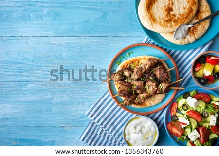 Greek souvlaki with pita bread, tzatziki sauce and salad.Copy space