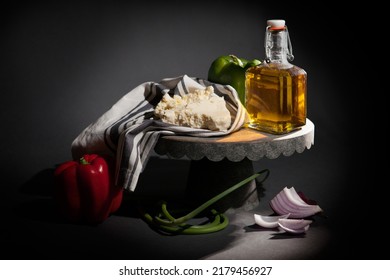 Greek Still Life Of Feta Cheese, Bell Peppers, Olive Oil, Garlic Scapes And Red Onion