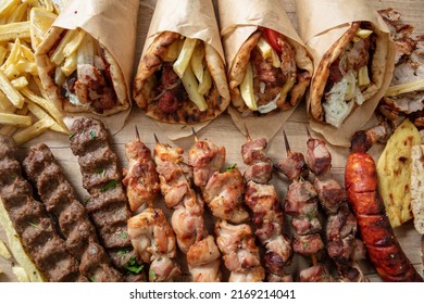 Greek Street Food Variety, Gyro Sliced Meat Pita Bread Wrap, Chiken And Pork Souvlaki Skewer. Wooden Table, Top View