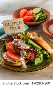 Greek Stuffed Turkey Burger Topped With Cucumber Slices And Tzatziki Yogurt Sauce Served With Mediterranean Street Cart Fried Potatoes With Feta Cheese Olives Herbs And Spices