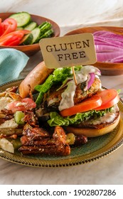 Greek Stuffed Turkey Burger Topped With Cucumber Slices And Tzatziki Yogurt Sauce Served With Mediterranean Street Cart Fried Potatoes With Feta Cheese Olives Herbs And Spices