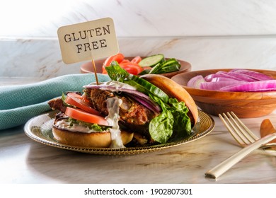 Greek Stuffed Turkey Burger Topped With Cucumber Slices And Tzatziki Yogurt Sauce Served With Mediterranean Street Cart Fried Potatoes With Feta Cheese Olives Herbs And Spices