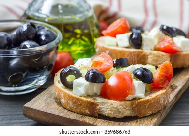 Greek style crostini with feta cheese, tomatoes, cucumber, olives and herbs - Shutterstock ID 359686763