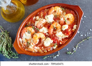 Greek Traditional Food. Oven Backed Prawns With Feta, Tomato, Paprika, Thyme In A Traditional Ceramic Form On A Abstract Background. Healthy Eating Concept. Mediterranean Lifestyle.