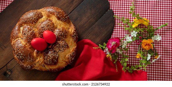 Greek tsoureki, Easter sweet bread, cozonac and red dye egg top view. Braided brioche, festive traditional dessert - Shutterstock ID 2126734922