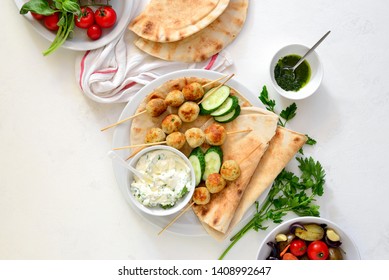 Greek Turkey Meatballs With Pita And Tzatziki, Top Down View On Table Setting With Meatballs Dish And Fresh Vegetables