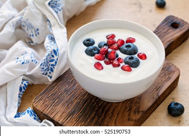 Greek yogurt with fresh blueberries and pomegranate seeds for healthy diet breakfast or snack. Close up view, horizontal - Powered by Shutterstock