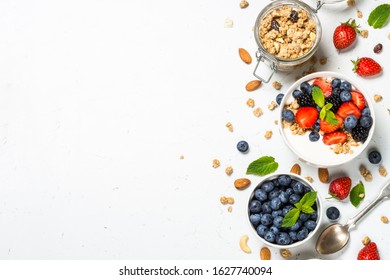Greek yogurt granola with fresh berries on white stone table, top view, copy space. Healthy food, snack or breakfast. - Shutterstock ID 1627740094