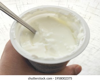 Greek Yogurt Pot In Woman Hand. 