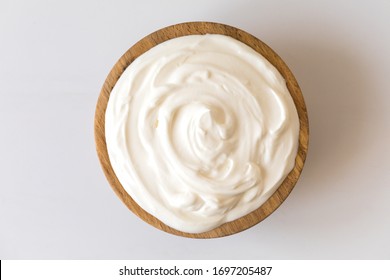 Greek yogurt in a wooden bowl. Healthy breakfast.Homemade Fatty Dairy product, sour cream, mayonnaise. - Shutterstock ID 1697205487