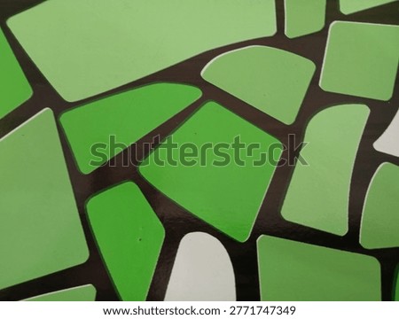 Green abstract mosaic pattern with irregular geometric shapes and black outlines.